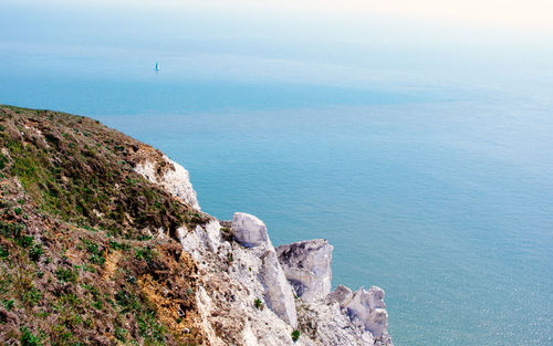 High angle view of rocks by sea against sky