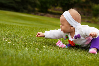 Cute baby girl on field