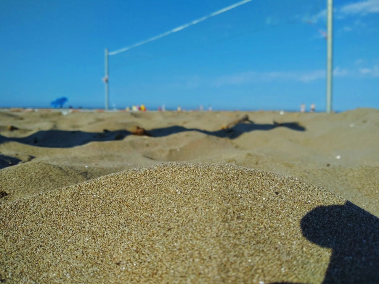 SURFACE LEVEL OF BEACH AGAINST SKY