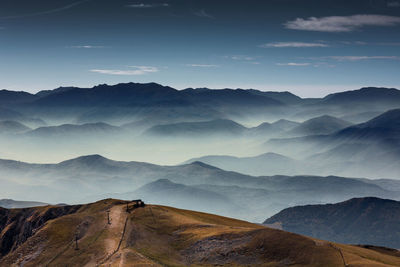 High angle view of silhouette mountains during foggy weather