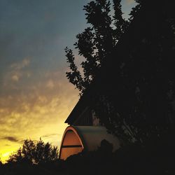 Low angle view of silhouette trees against sky during sunset