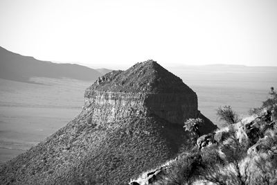 Scenic view of sea and mountains against sky