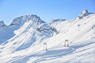 Scenic view of snow covered mountains against sky