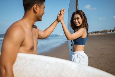 Portrait of young woman exercising at beach