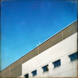 Low angle view of building against clear blue sky