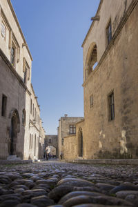 Low angle view of buildings against clear blue sky