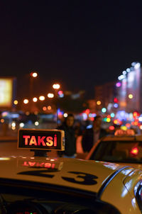 Taxi sign against defocused lights at night