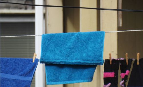 Towels hanging on string against building