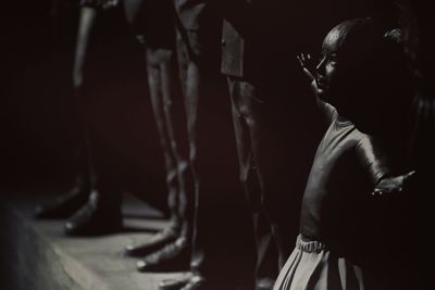 Side view of man standing against wall