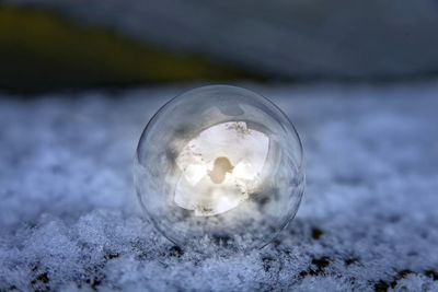 Close-up of crystal ball on snow