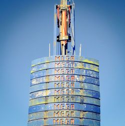 Low angle view of construction site against clear blue sky