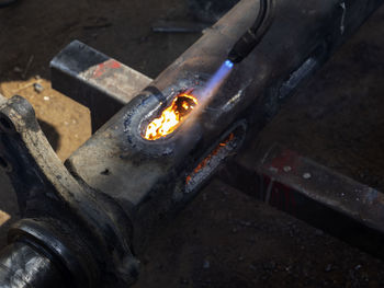 High angle view of illuminated candles on metal