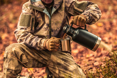 Rear view of soldier standing in forest