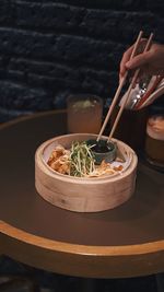 Midsection of person having food on table