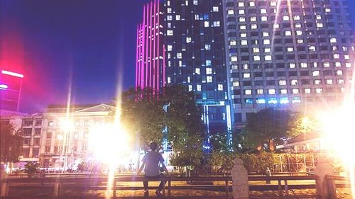 People on illuminated city at night
