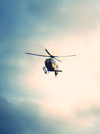 Low angle view of helicopter against sky