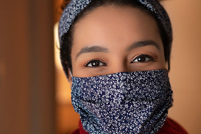 Close-up portrait of woman covering face