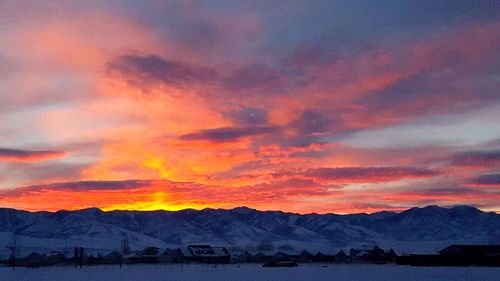 Scenic view of mountains against sky at sunset