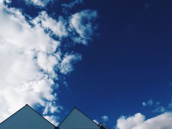 Low angle view of building against cloudy sky