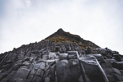Low angle view of rock formation against sky