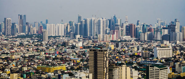 High angle view of modern buildings in city against sky