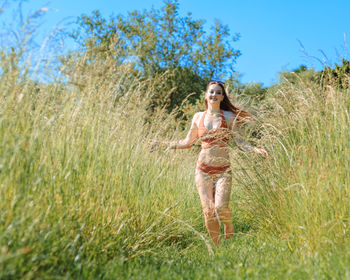 Full length of woman standing on field