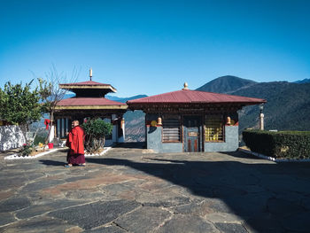 Gazebo by building against clear blue sky