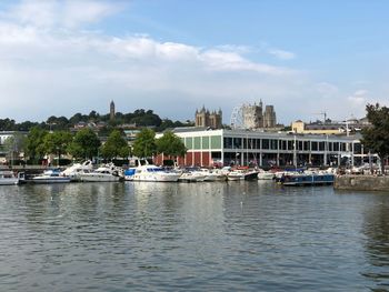 Boats in river with buildings in background