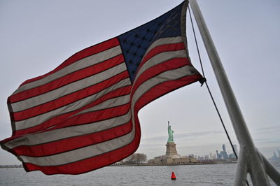 Low angle view of flag against clear sky