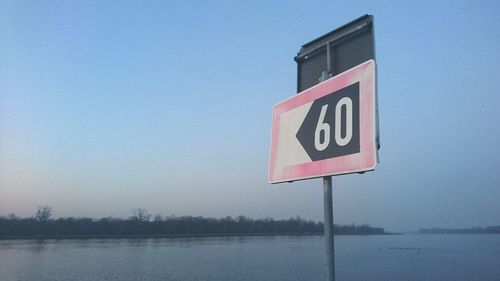 Close-up of road sign against clear sky