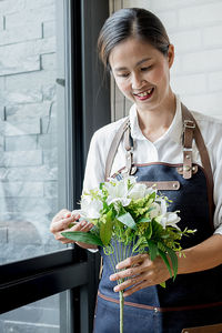 Young woman holding flower bouquet