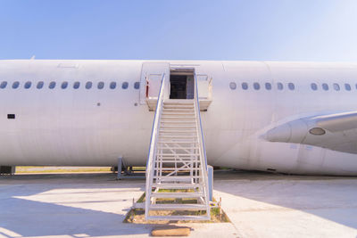 Abandoned airplane at airport against sky