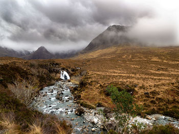Scenic view of land against sky during winter, waterfall, scotland, isle of skye