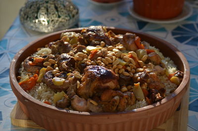 High angle view of rice casserole with turkey in bowl on table