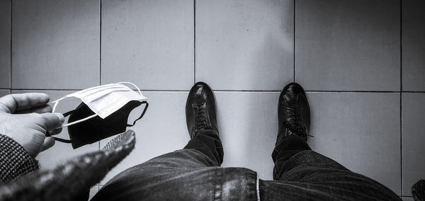 Low section of man sitting on tiled floor