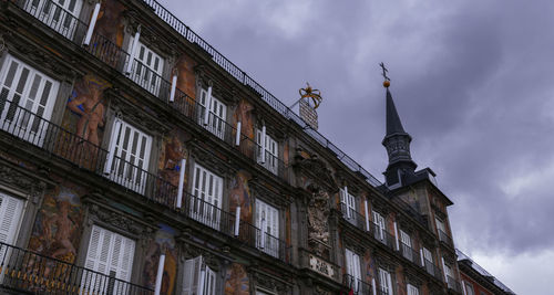 Low angle view of old building against cloudy sky