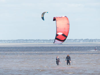 People on beach against sky