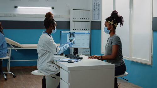 Female doctor examining chemical in laboratory