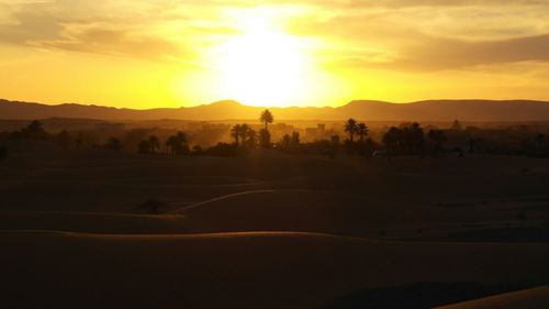 Scenic view of silhouette landscape against sky during sunset