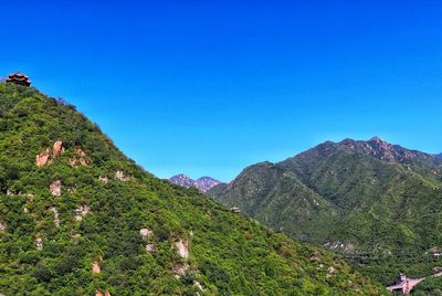 Scenic view of mountains against clear blue sky