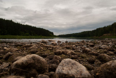 Scenic view of lake against cloudy sky