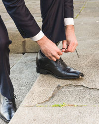 Low section of man standing on street