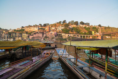 River amidst buildings in city against clear sky