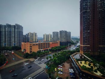 High angle view of city street and buildings against sky