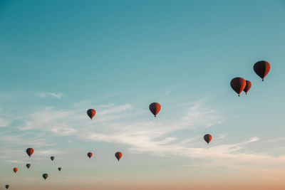 Hot air balloons flying against sky