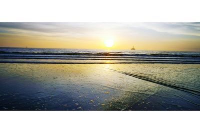 Scenic view of beach against sky during sunset