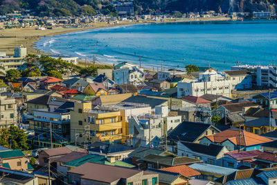 High angle view of townscape by sea