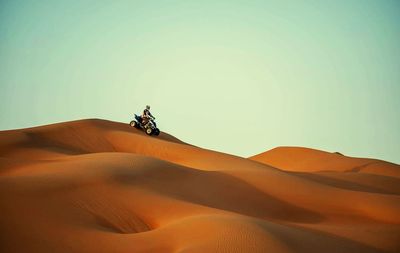 Man riding quadbike in desert