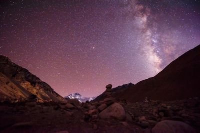 Scenic view of mountains against sky at night