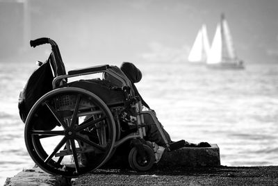 Full length of wheelchair on pier